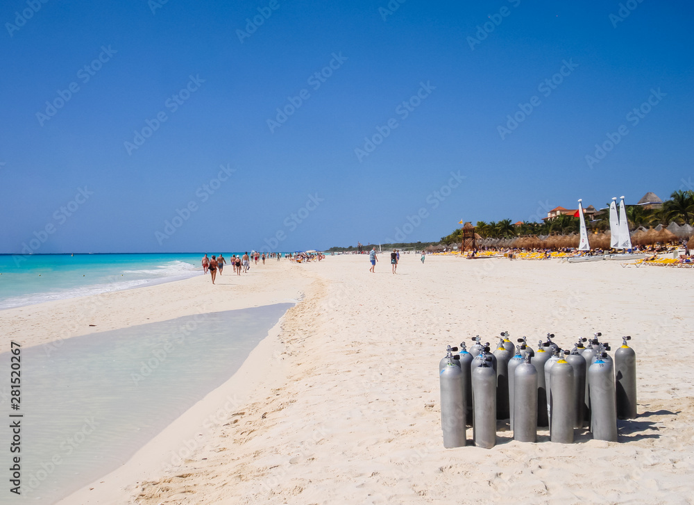 Playa del Carmen, Mexico - March 23, 2010: Several scuba diving tanks stacked on the beach to be used by a group of tourists who are going to dive in the Caribbean waters.