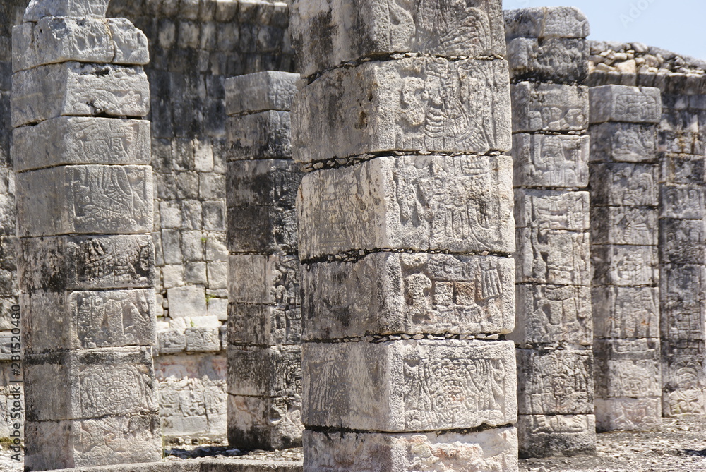 Carved stone columns with Mayan images in Chichen Itza, Mexico.