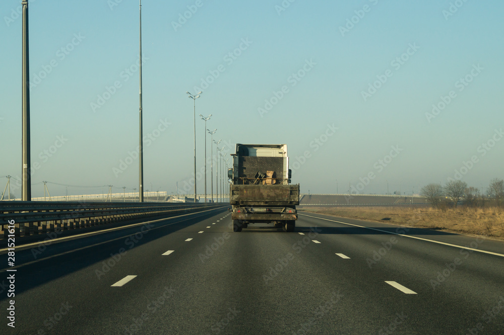 Delivery truck driving on a highway. car moving on a roadway