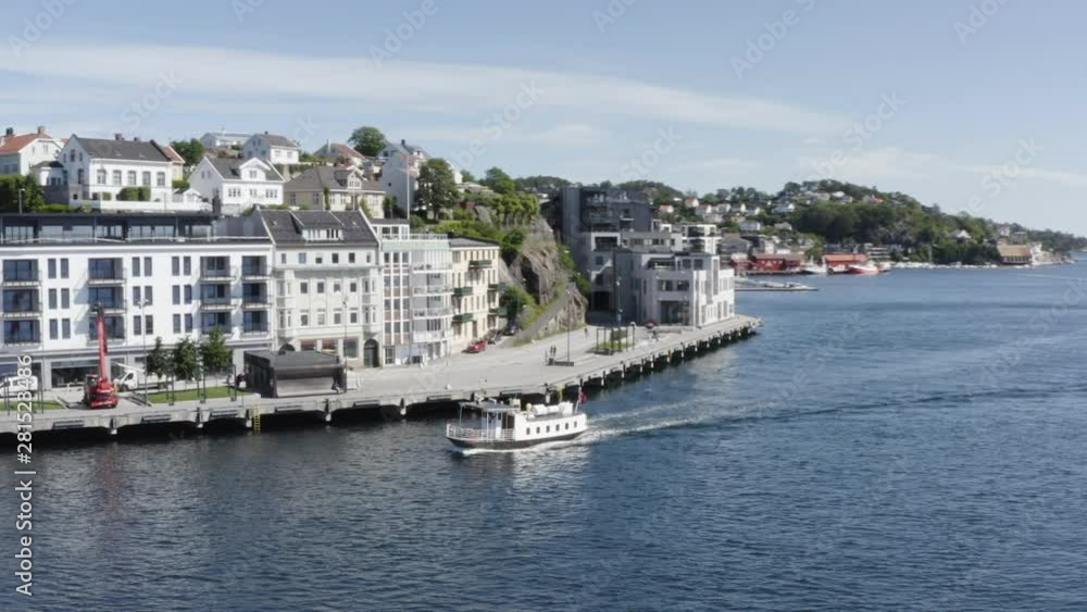 Drone shot of a ferry boat in Arendal, Norway. Aerial orbital shot. Drone shot of a ferry boat in Arendal, Norway. Aerial orbital shot.
