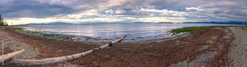 Wide Panoramic Scenic Landscape View of Rathtrevor Beach Provincial Park on Vancouver Island and Dramatic Sunset Sky over Strait of Georgia, British Columbia Canada