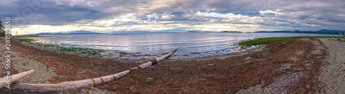Wide Panoramic Scenic Landscape View of Rathtrevor Beach Provincial Park on Vancouver Island and Dramatic Sunset Sky over Strait of Georgia, British Columbia Canada photo