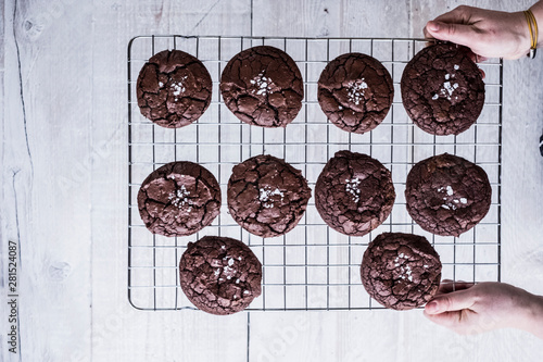 Overhead view of woman holding cooling rack of chocolate brownies photo