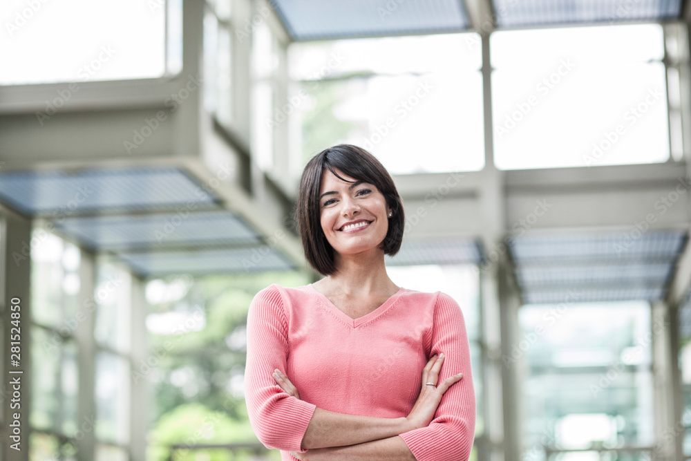 Portrait of smiling businesswoman standing in lobby of convention center