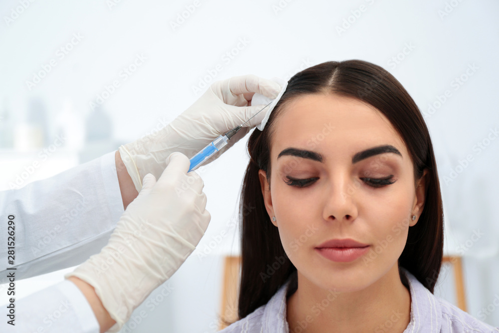 Young woman with hair loss problem receiving injection in salon Young woman with hair loss problem receiving injection in salon