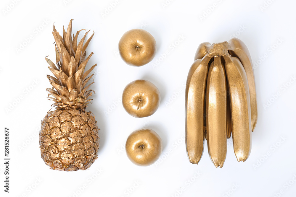 Composition with gold fruits on white background, top view Stock Photo