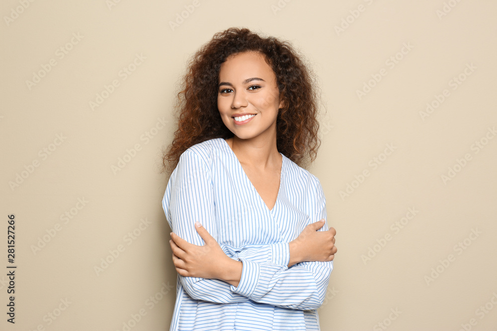 Young African-American woman with beautiful face on beige background Young African-American woman with beautiful face on beige background