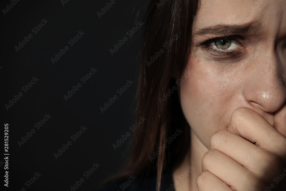 Crying young woman on dark background, space for text. Stop violence Crying young woman on dark background, space for text. Stop violence