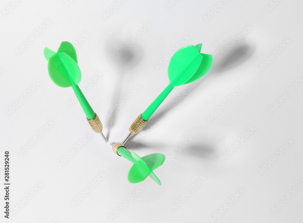 Green dart arrows for game on white background, above view Green dart arrows for game on white background, above view