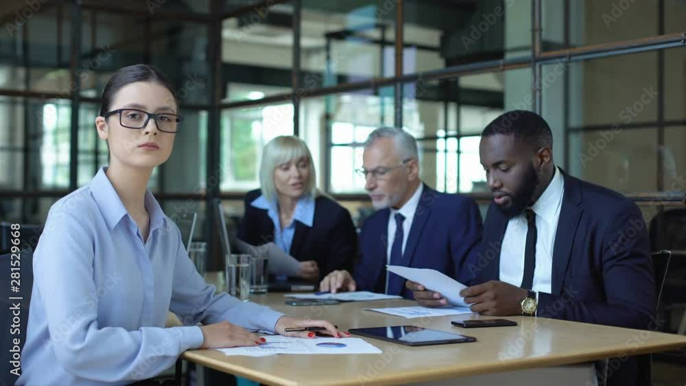 Experienced female employee in eyeglasses looking camera, consulting service Experienced female employee in eyeglasses looking camera, consulting service