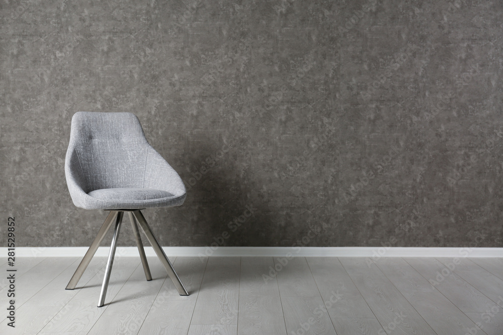 Grey modern chair for interior design on wooden floor at gray wall Grey modern chair for interior design on wooden floor at gray wall