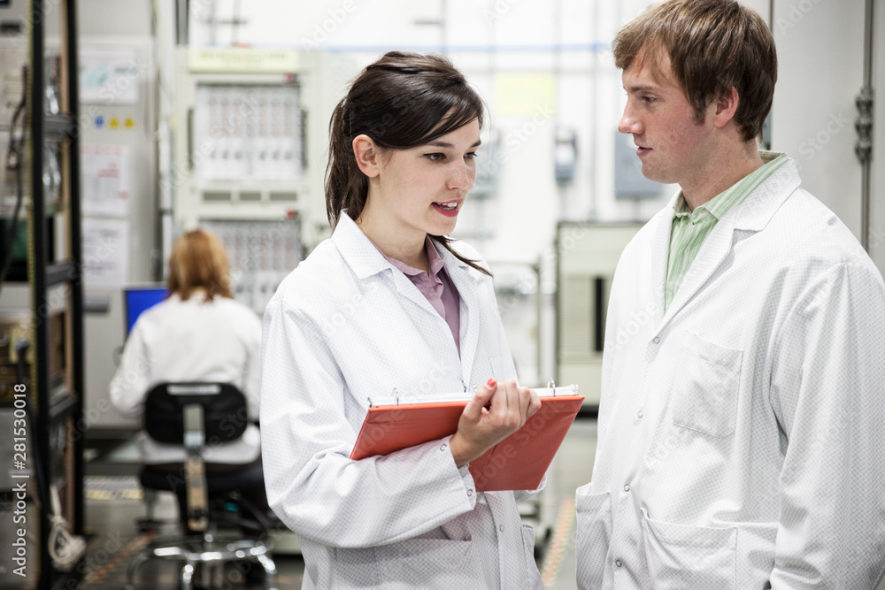 Technicians talking in laboratory Technicians talking in laboratory