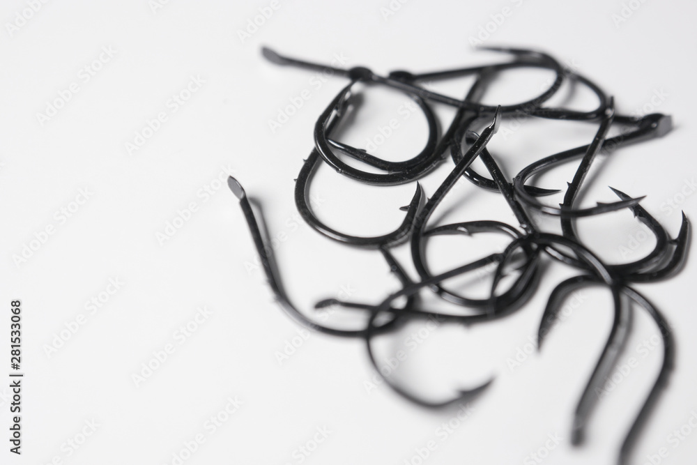 Barbed, spade end fishing hooks on white background. Copy space on left. Barbed, spade end fishing hooks on white background. Copy space on left.