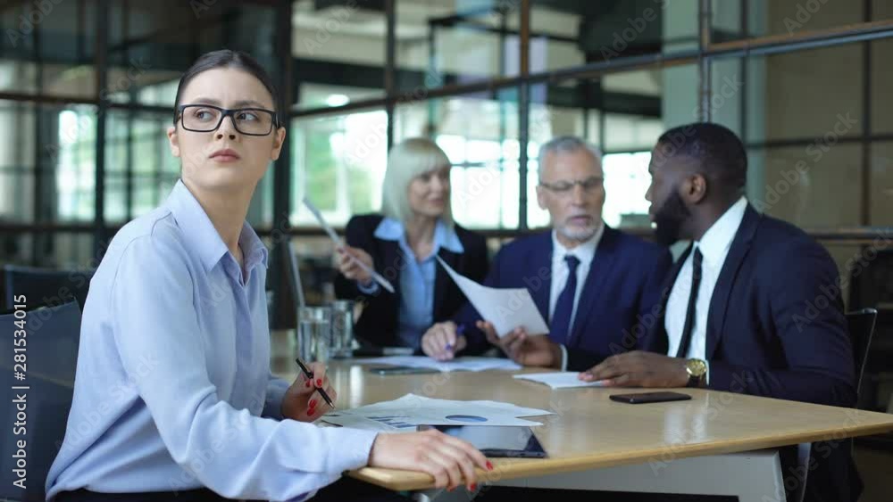 Sad female manager looking window during office meeting, workload tiredness Sad female manager looking window during office meeting, workload tiredness