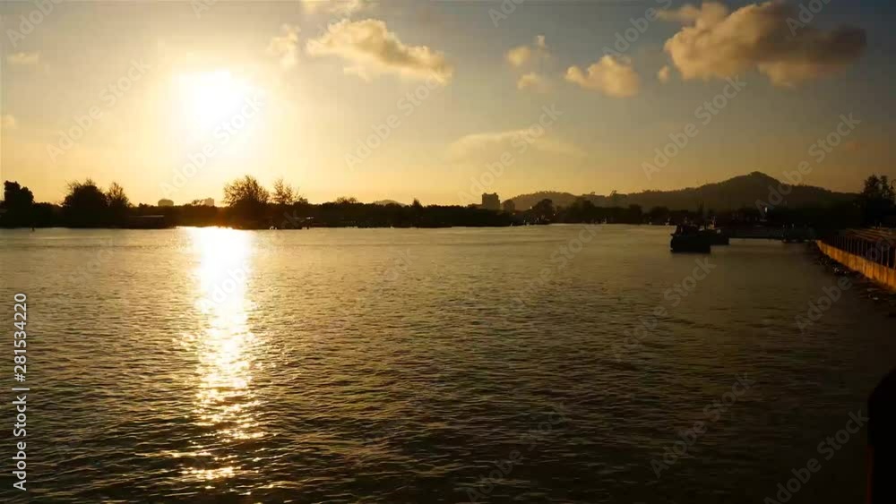 Timelapse of orange sky as sun sets over the sea with fast moving cloud Timelapse of orange sky as sun sets over the sea with fast moving cloud
