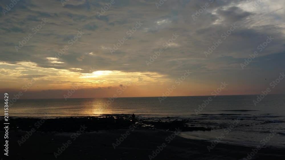 Timelapse of orange sky as sun rise over the sea with fast moving cloud Timelapse of orange sky as sun rise over the sea with fast moving cloud