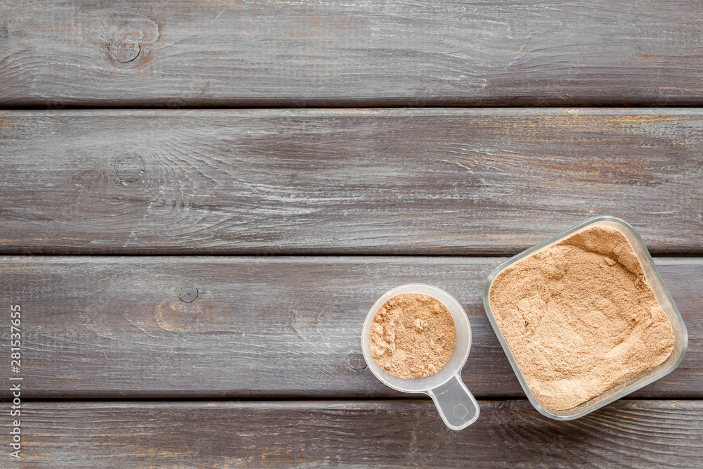 protein powder for fitness nutrition on wooden background top view mock-up protein powder for fitness nutrition on wooden background top view mock-up