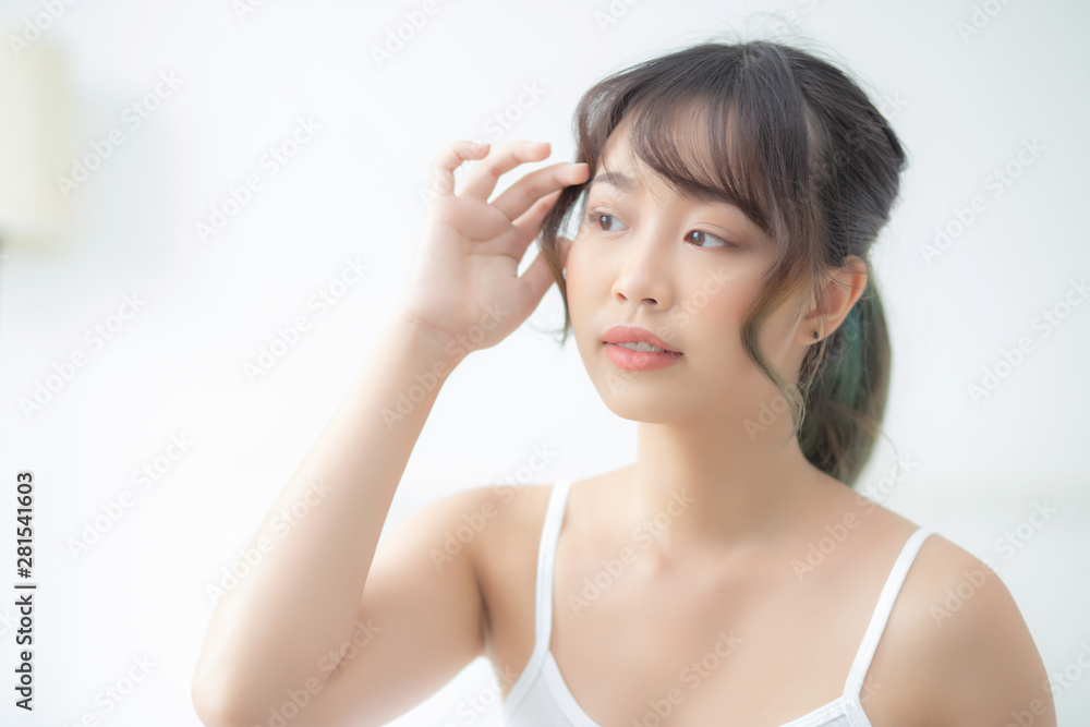 Portrait of beautiful young asian woman smile while wake up healthy and wellness with sunrise at morning in the bedroom, asia girl skin care with happy with fresh, lifestyle and relax concept. Portrait of beautiful young asian woman smile while wake up healthy and wellness with sunrise at morning in the bedroom, asia girl skin care with happy with fresh, lifestyle and relax concept.