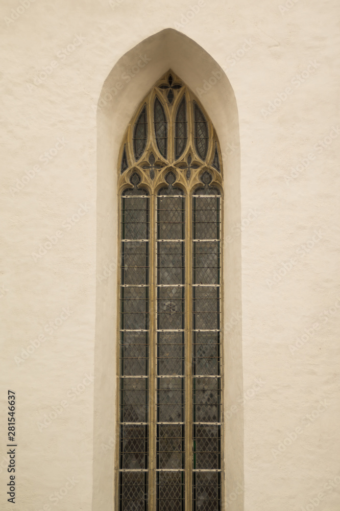 Unusual window on the facade of the old house