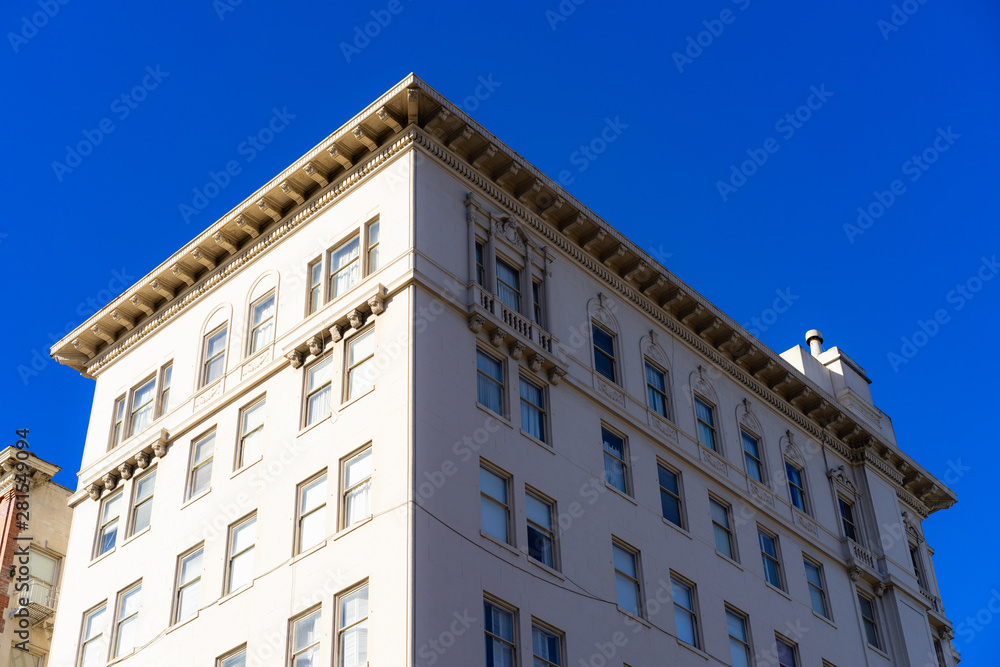 The corner of a building with a blue sky in the background