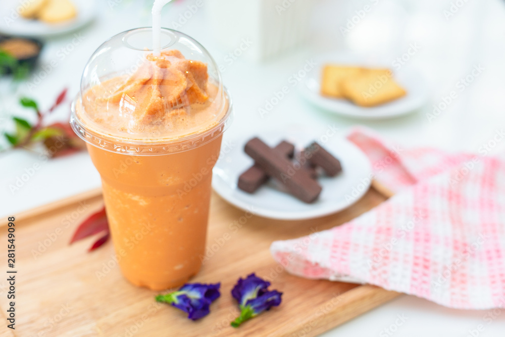 Milk tea or Thai milk tea on the wooden plate. Milk tea or Thai milk tea on the wooden plate.