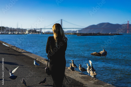 Girl walking with birds in the background