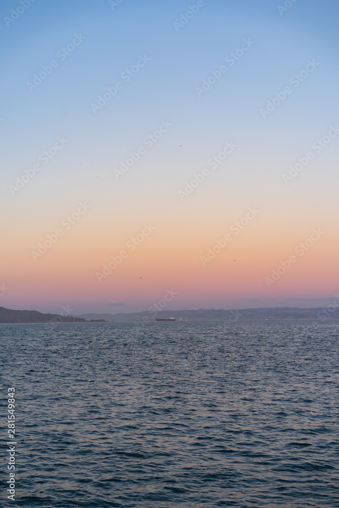 Sunset on the water with blues, purples and pink color sky