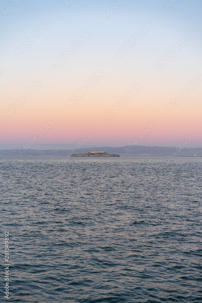 Ocean sunset with a cargo boat in the background