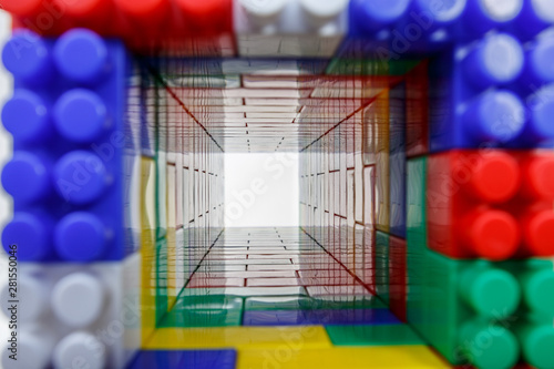 Square tunnel of children's colorful plastic construction toy bricks on white