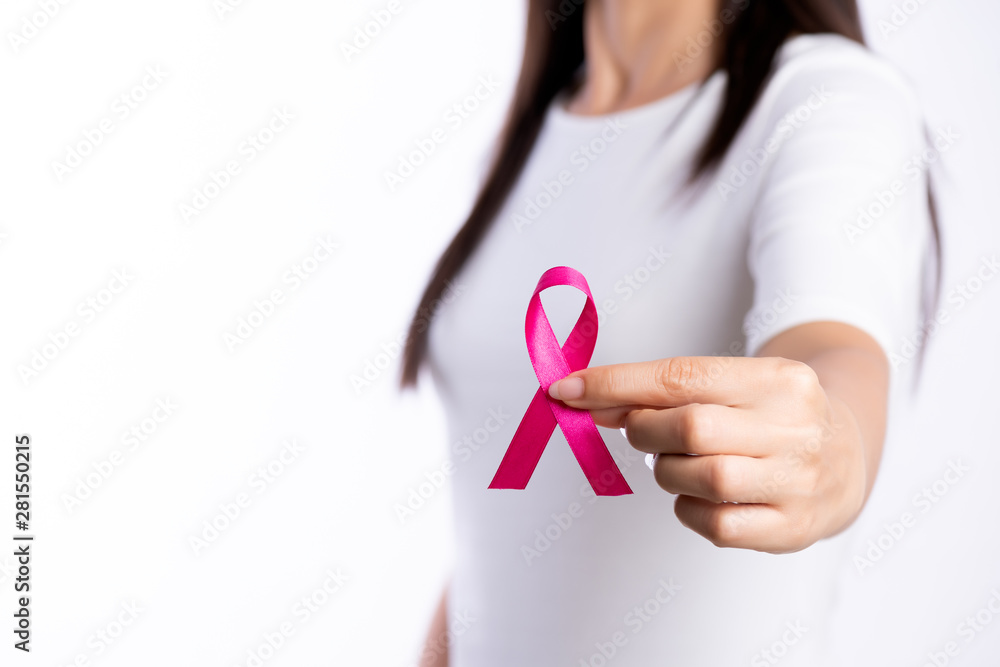womaen hand holding pink ribbon breast cancer awareness. concept healthcare and medicine. womaen hand holding pink ribbon breast cancer awareness. concept healthcare and medicine.