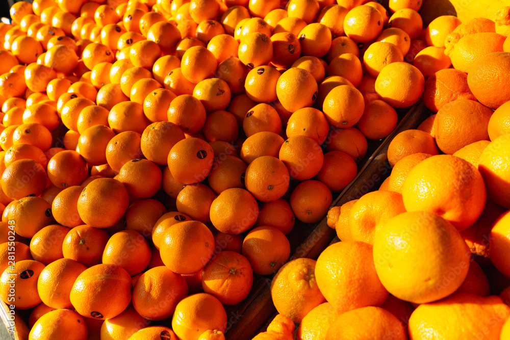 Bulk oranges for sale on a stand in a market