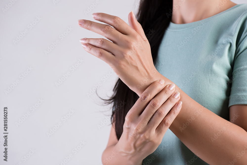 Closeup woman holds her wrist hand injury, feeling pain. Health care and medical conept. Closeup woman holds her wrist hand injury, feeling pain. Health care and medical conept.