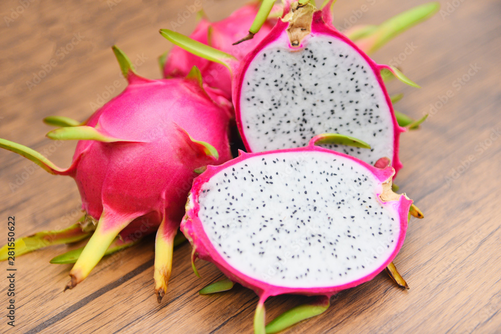 Dragon fruit slice on wooden background - Fresh pitaya summer tropical fruit concept Dragon fruit slice on wooden background - Fresh pitaya summer tropical fruit concept