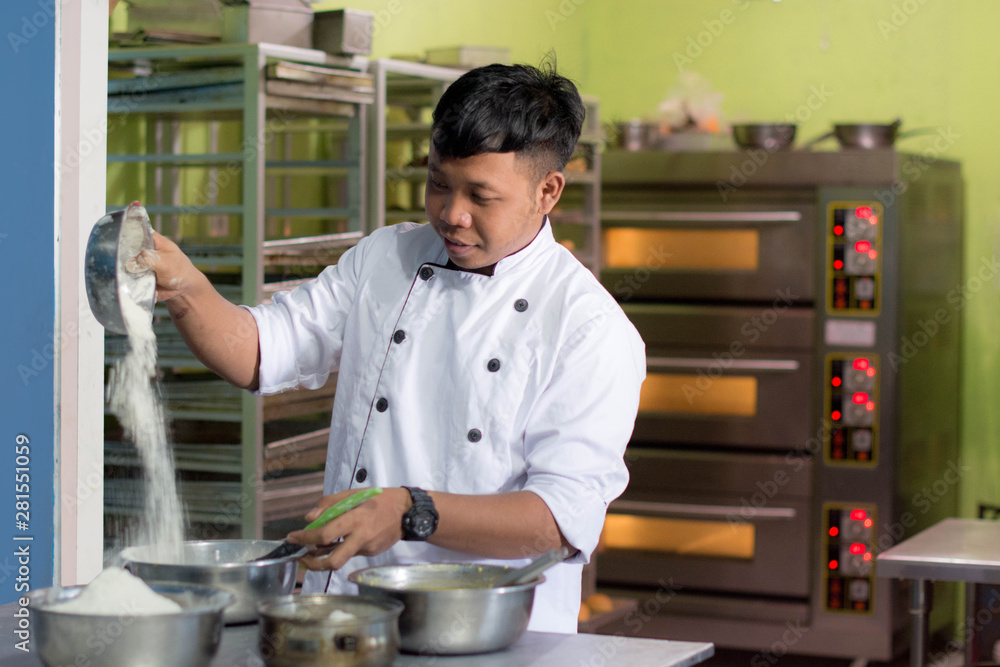 Fototapeta premium pastry chef with ingridient at kitchen
