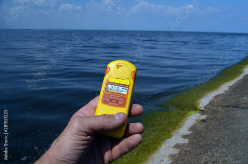 Geiger counter near storage pool near of hydroelectric station. After Chernobyl disaster - collection active sediments.The radiometer gives readings in micro-Sieverts. LOGO REMOVED. Kiev ,Ukraine