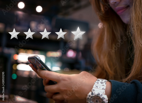 Woman internet shopping on smartphone submitting 5 silver star satisfaction feedback - Millennial girl reply to customer experience survey questions by email - Review, success & retention concept