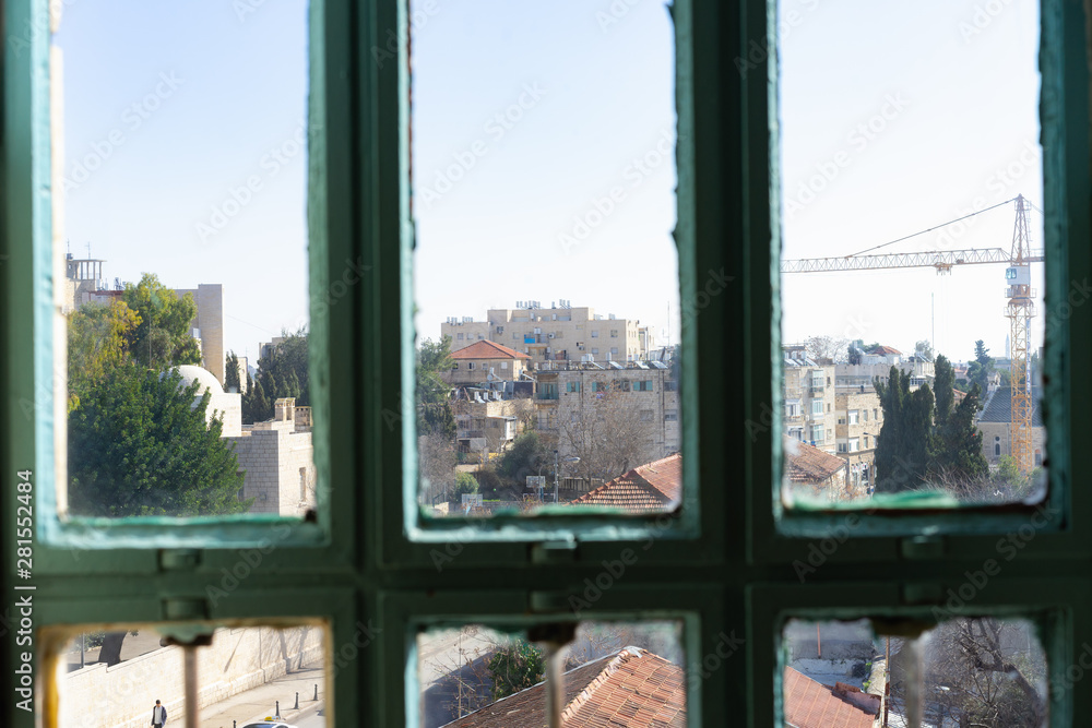 Looking out of a old green window in Tel Aviv, Israel