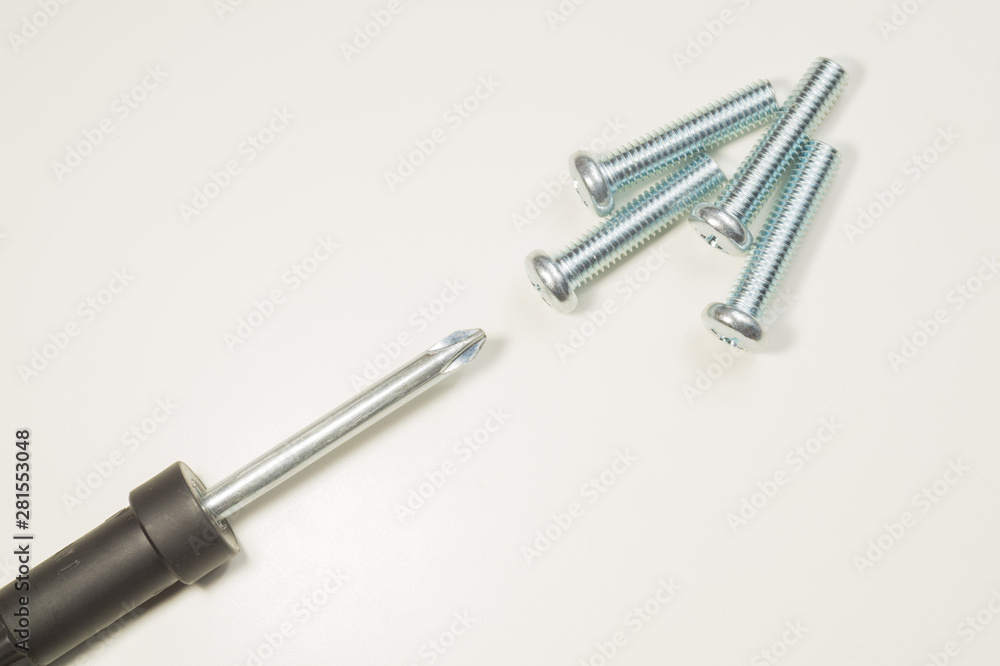 Screwdriver and screws on a white background Screwdriver and screws on a white background