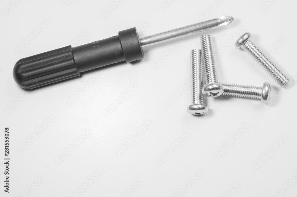 Screwdriver and screws on a white background