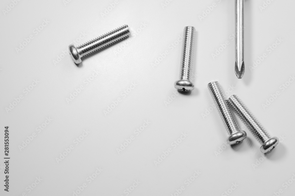 Screws and screwdriver on a white background Screws and screwdriver on a white background