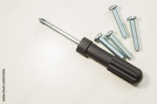 Screwdriver and screws on a white background