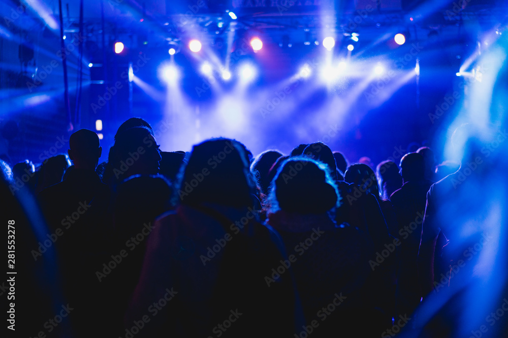 Tel Aviv, Israel February 23, 2018: Blue lights at a concert with people in the foreground