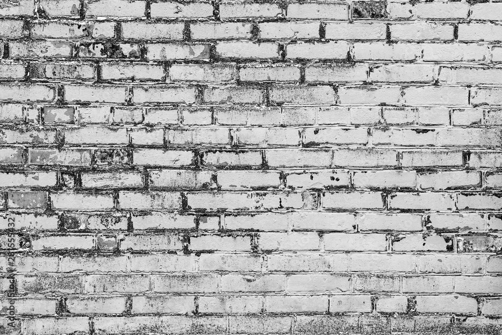 Fototapeta premium Texture of a brick wall with cracks and scratches which can be used as a background