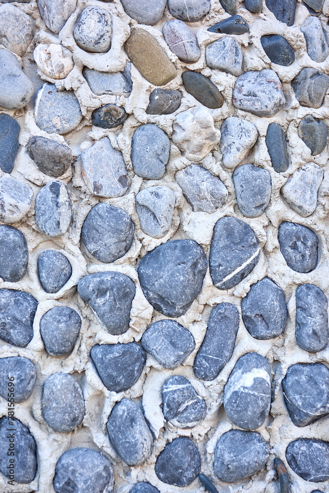 The texture of sea pebbles in cement closeup. The texture of sea pebbles in cement closeup.