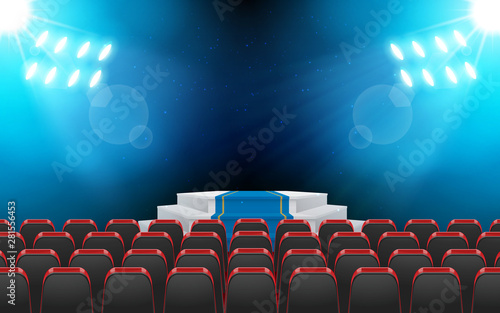 chairs and stage with spotlight in the hall