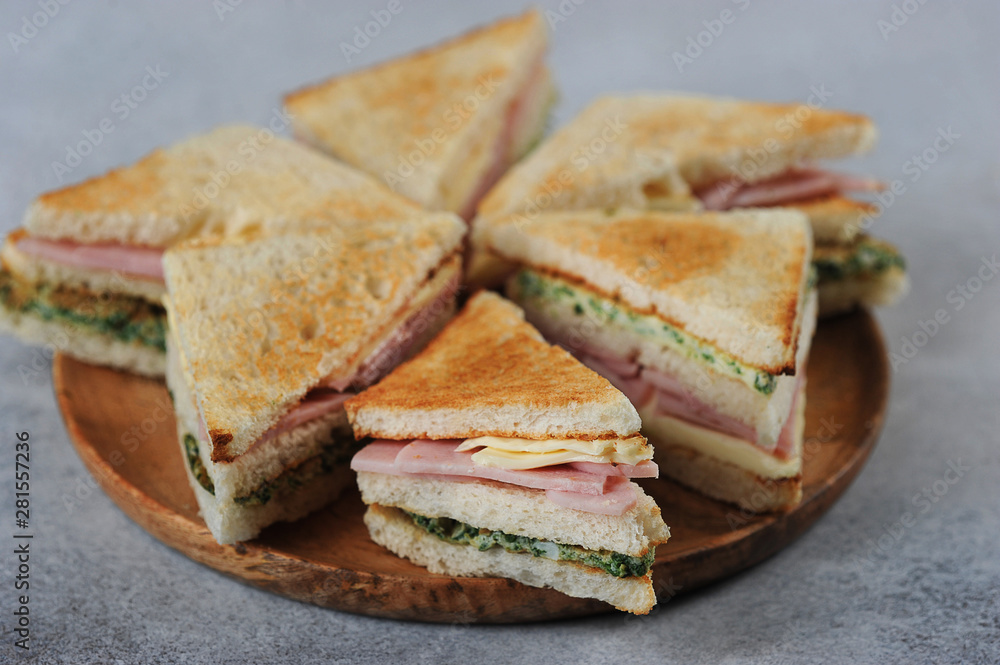 ham and cheese sandwich on a wooden plate