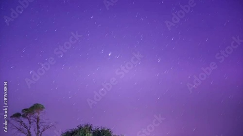 Day to night sunset timelapse with star trails and comets featuring a lone tree in Hunter valley, NSW, Australia photo