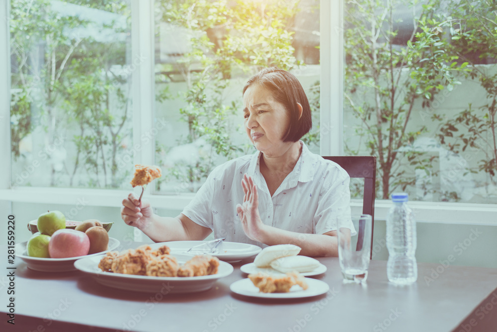 Senior asian woman feeling unhappy and bored meal,Elderly healthy concept,Bored with food