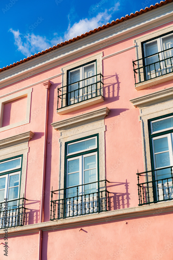 Fototapeta premium Pink house with windows and balconies