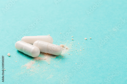White medicine capsules probiotic powder inside. Close up. High resolution product. Health care concept - Image photo